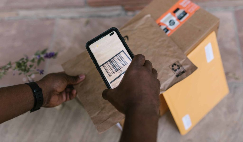 Courier scanning a package that is being delivered